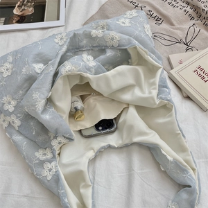 Detailed interior of light blue floral embroidered tote bag with a zipper pocket