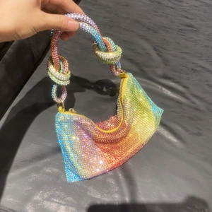 Close-up of rainbow gradient rhinestone evening bag with iconic knotted handle detail