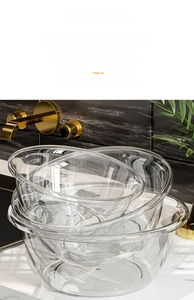 Detail of thickened transparent PET washbasins set with high clarity on marble countertop