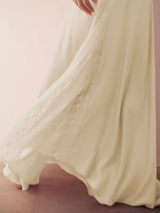 Dynamic detail of champagne satin skirt with delicate lace patchwork and silky sheen