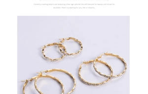 Detailed view of three gold-plated wavy hoop earrings with shimmering white rhinestones