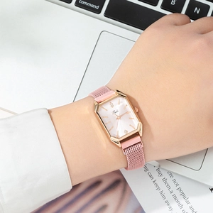 Elegant rose gold mesh strap quartz watch for women with rectangular case on wrist