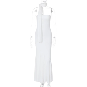 Detail of a white strapless bodycon dress with matching neck scarf and mermaid hemline