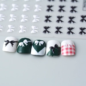 Detail of 5D embossed bow-knot nail stickers with black and white satin texture effects
