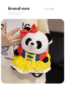 Close-up of cute panda plush toy wearing a colorful princess dress with red bow