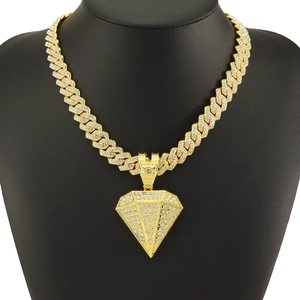 Close-up of golden pyramid pendant with diamonds on a black mannequin display neck