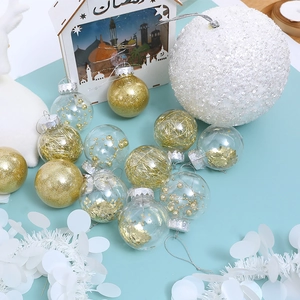 Detailed view of clear Christmas balls with gold glitter, sequins, and white textured ornaments