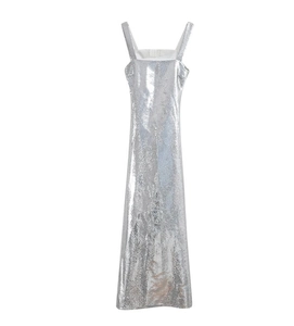 Detailed close-up of shiny silver sequins on a slim fit evening gown with metallic texture