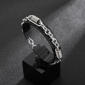 Minimalist stainless steel O-chain bracelet with spring elements on black display