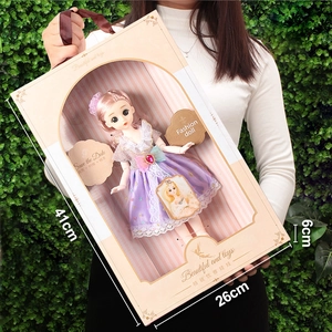 Detailed packaging view showing a 41cm fashion doll in a purple lace dress gift box