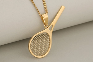 Macro shot showing the intricate grid texture of a gold tennis racket pendant necklace