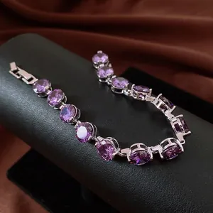 S-curve view of luxury silver bracelet with purple circular zirconia stones and buckle