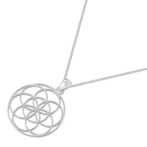 Detailed macro view of silver hollow tree of life pendant with intricate geometric patterns
