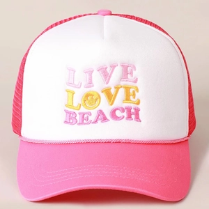 Pink and white trucker hat featuring Live Love Beach embroidery and mesh back