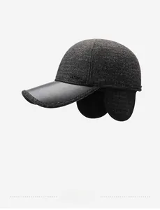Winter baseball cap with ear flaps featuring wool-like fabric and leather brim detail