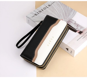 Detail of color-block leather wallet with lychee texture and dual metal zippers