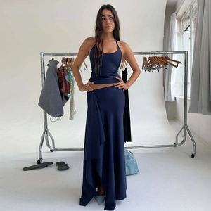 Detail of a navy blue two-piece set featuring a halter top and irregular maxi skirt