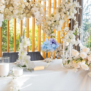 Golden metal ring wedding centerpiece with wooden base and floral accents