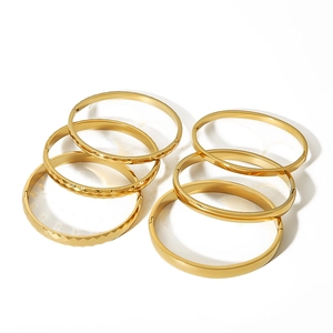 7-piece 18k gold plated titanium steel bangle set featuring diamond-cut and smooth finishes