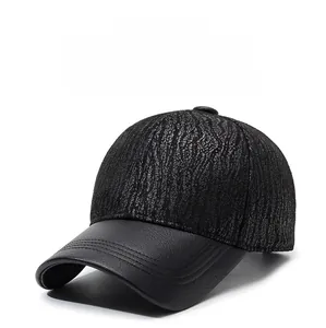 Close-up of black baseball cap showing bark texture fabric and faux leather brim detail