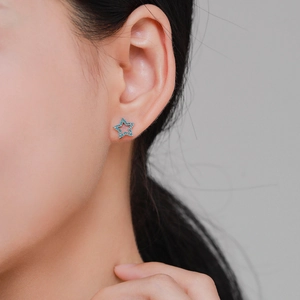 925 Sterling silver star stud earrings with turquoise stones worn by a model