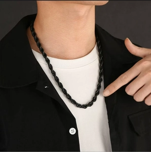Close-up of black braided twist chain necklace on male model with sleek metal finish