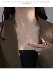 Detail of S925 sterling silver rectangular necklace with engraved letter K pendant