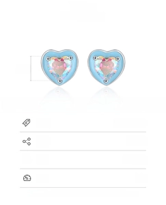 Macro detail of 925 sterling silver heart earrings with blue enamel and colorful zircon