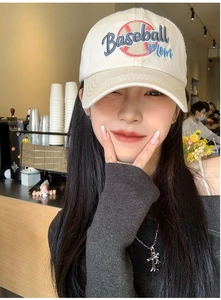 Detailed embroidery of Baseball Mom text and graphic on a beige cotton baseball cap