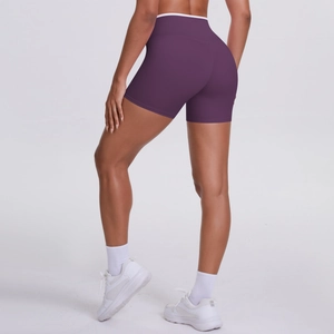 Detail of purple high waisted biker shorts with white contrast trim and peach lift effect