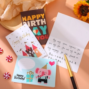 Detail of birthday card set with gold foil castle and handwritten greeting message
