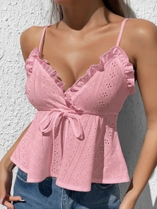 Detail of pink eyelet embroidery cotton camisole with ruffle V-neck and waist tie