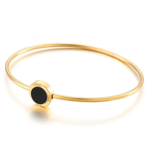 Minimalist gold stainless steel open bangle with black resin disk and LOVE FOR engraving