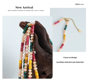 Detail of colorful beads and freshwater pearls necklace with gold lobster clasp