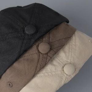 Short brim baseball caps in black, brown, and beige with detailed stitching and air vents