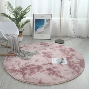 Close-up of a pink and white tie-dye round plush rug on light wood flooring in a room