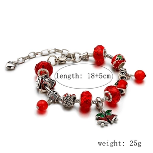 Detail view of red beaded Christmas bracelet with silver bell and heart charms 18+5cm