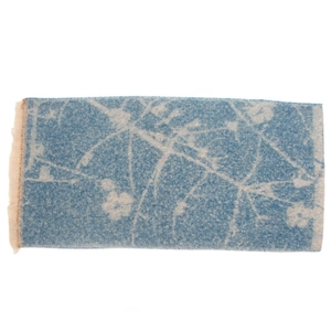 Close-up of blue and off-white jacquard flower scarf with delicate short fringes