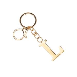 Close-up of golden stainless steel letter L keychain with lobster clasp on white background