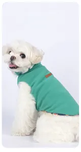 Detail of mint green double-sided fleece pet vest with premium leather brand label