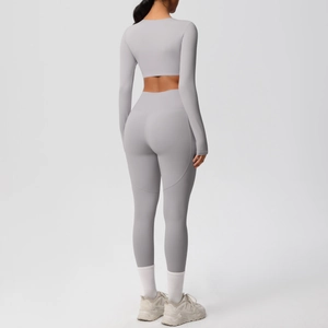 Detail view of high-waist seamless yoga leggings with peach lift stitch design