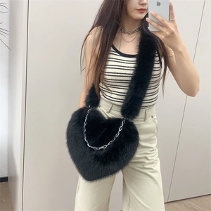 Furry heart-shaped crossbody bag in black with a stylish silver chain for winter fashion