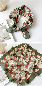 Detailed close-up of dark green floral cotton linen scarf with white daisy pattern print