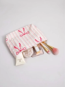 Pink striped cotton makeup bag with red bow print and zipper closure for cosmetics