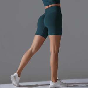 Detail view of seamless high-waisted dark teal biker shorts with scrunch butt lift texture