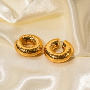 Detail of 18K gold plated stainless steel hoop earrings with hammered texture on silk