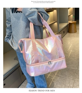Detail of holographic pink travel bag showing the bottom shoe compartment and pearly texture