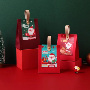 Christmas gift boxes with leather handles on a festive red stand with green background