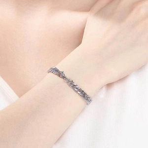 Minimalist silver stainless steel curb chain bracelet with lobster clasp on a model wrist