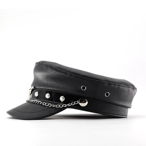 Detail of black faux leather military cap featuring silver chain and rivet accents
